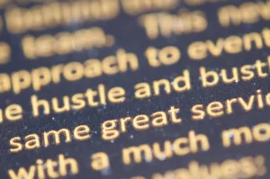 selective focus photography of hustle and bust text