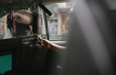passenger using credit card for paying taxi ride